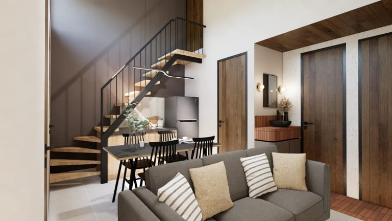 Ruang keluarga Mula Sudimara — living room hangat dengan pencahayaan warm dan area makan tangga